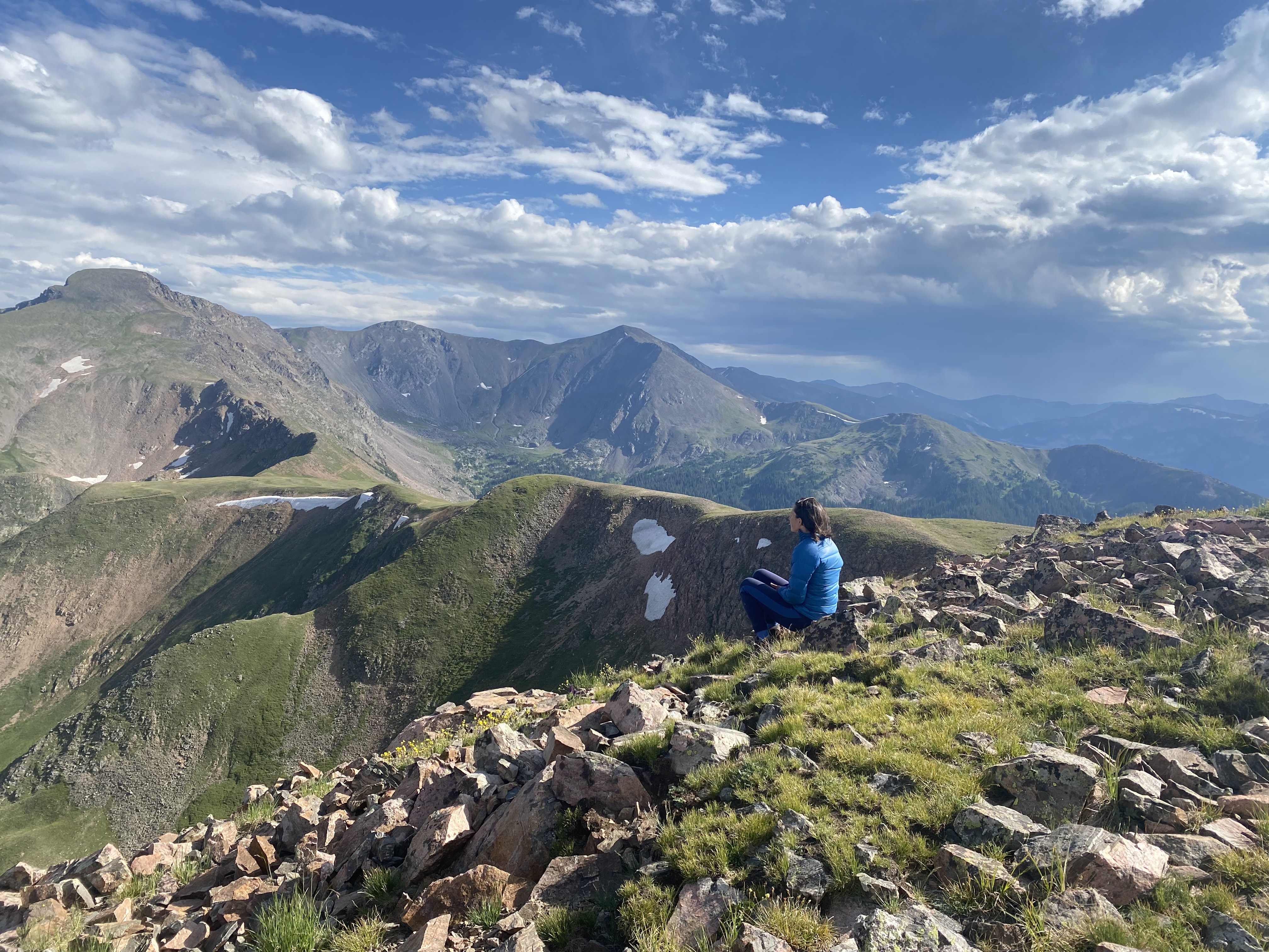 Sitting on a ridge line looking out at vast Rockies